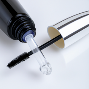 Close-up image of a bottle of eyelash serum with its lid unscrewed.