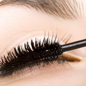 A closeup of mascara being applied to an eyelash.