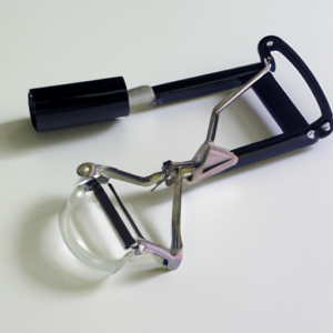 A close-up of an eyelash curler with its protective cover removed.