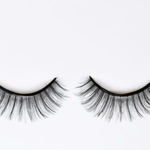 A close-up of a pair of false eyelashes with a magnetic backing.