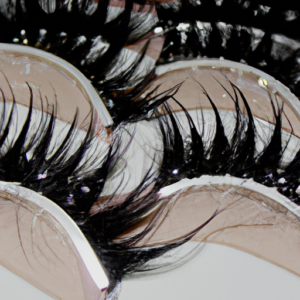 A close-up of a set of eye lashes with a subtle sparkle effect.