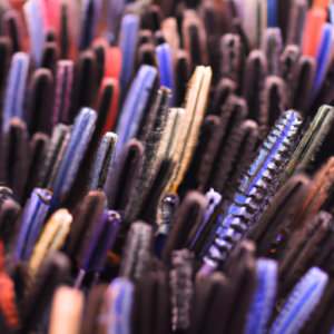 A close-up of a selection of colorful mascaras arranged in a fan shape.