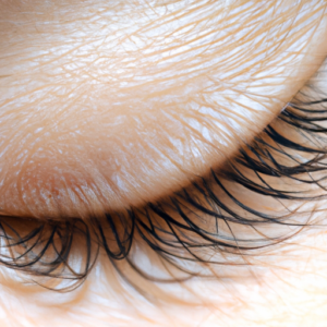 Close-up of a pair of long and curly eyelashes.