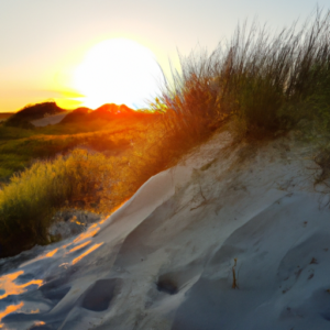 A sun-kissed beach with a golden sand dune and a glowing sunset.