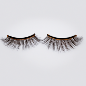 A pair of natural-looking false eyelashes lying on a white background.