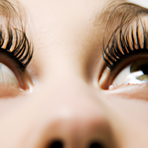 A closeup of a pair of eyes with exaggeratedly long eyelashes curling upwards.