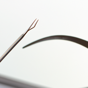 An arching eyebrow with a pair of tweezers in the foreground.