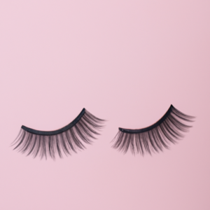A pair of false eyelashes lying on a light pink background.