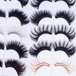 A close-up of several different types of synthetic eyelashes arranged in a fan shape.