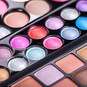 A close-up of a colorful cosmetic palette with a variety of makeup products.