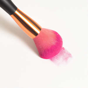A makeup brush dabbing a bright pink blush onto a white background.
